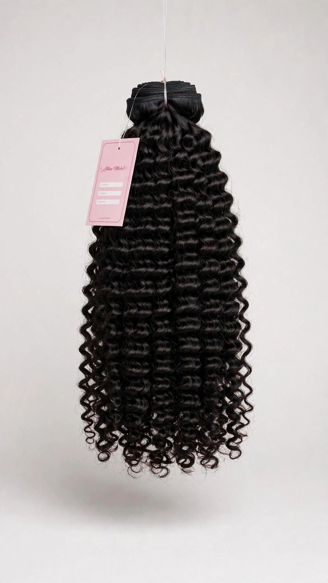 Raw curly human hair bundle with Lillian Michel Co. tag